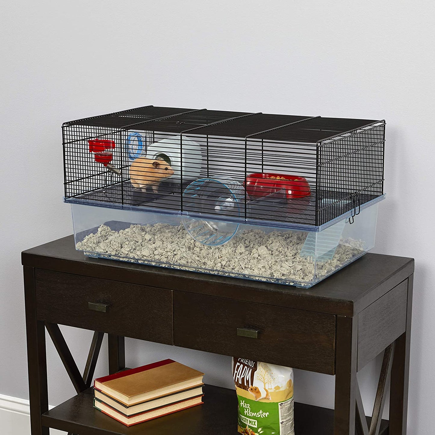 Hamster cage includes water bottle, wheel, tray