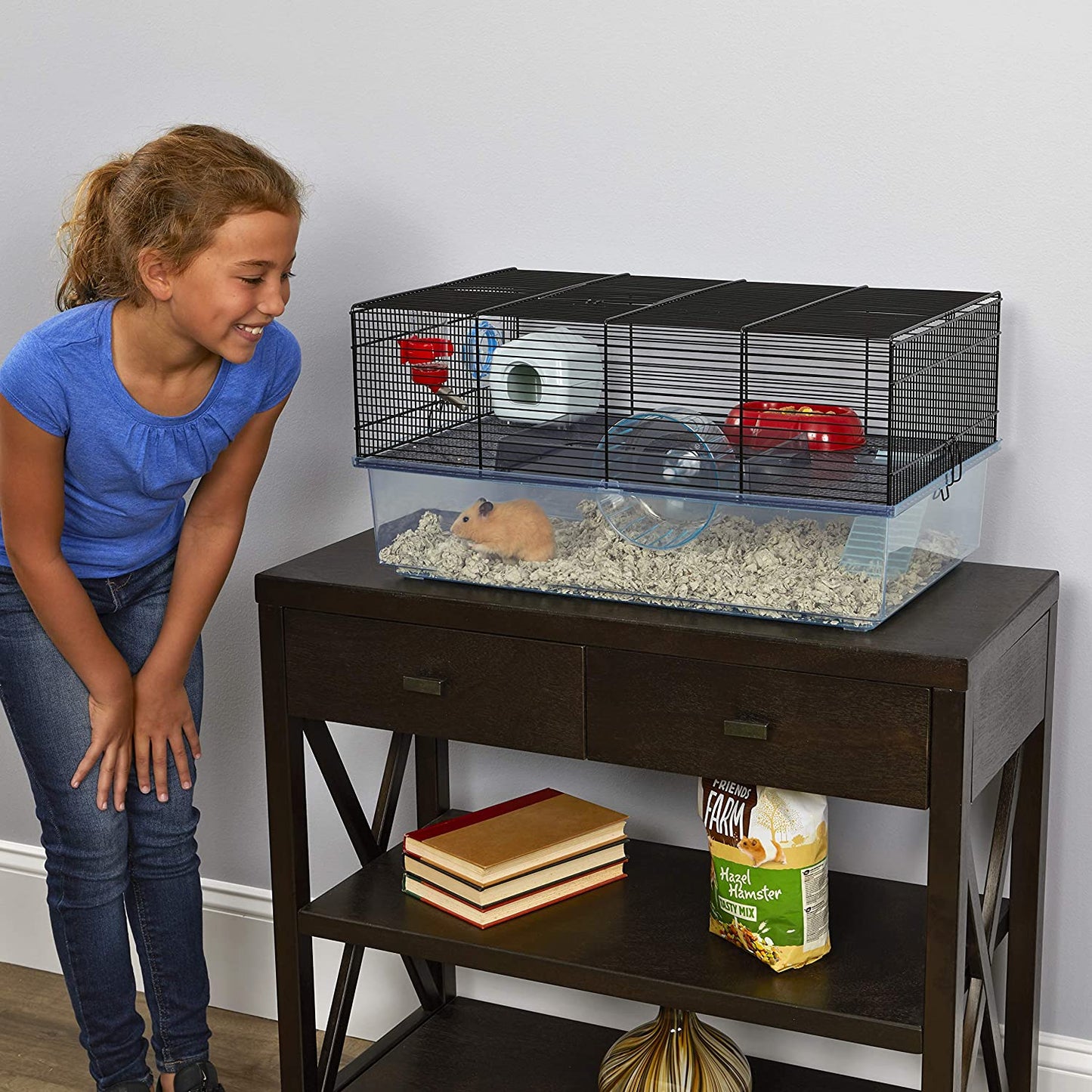 Hamster cage includes water bottle, wheel, tray